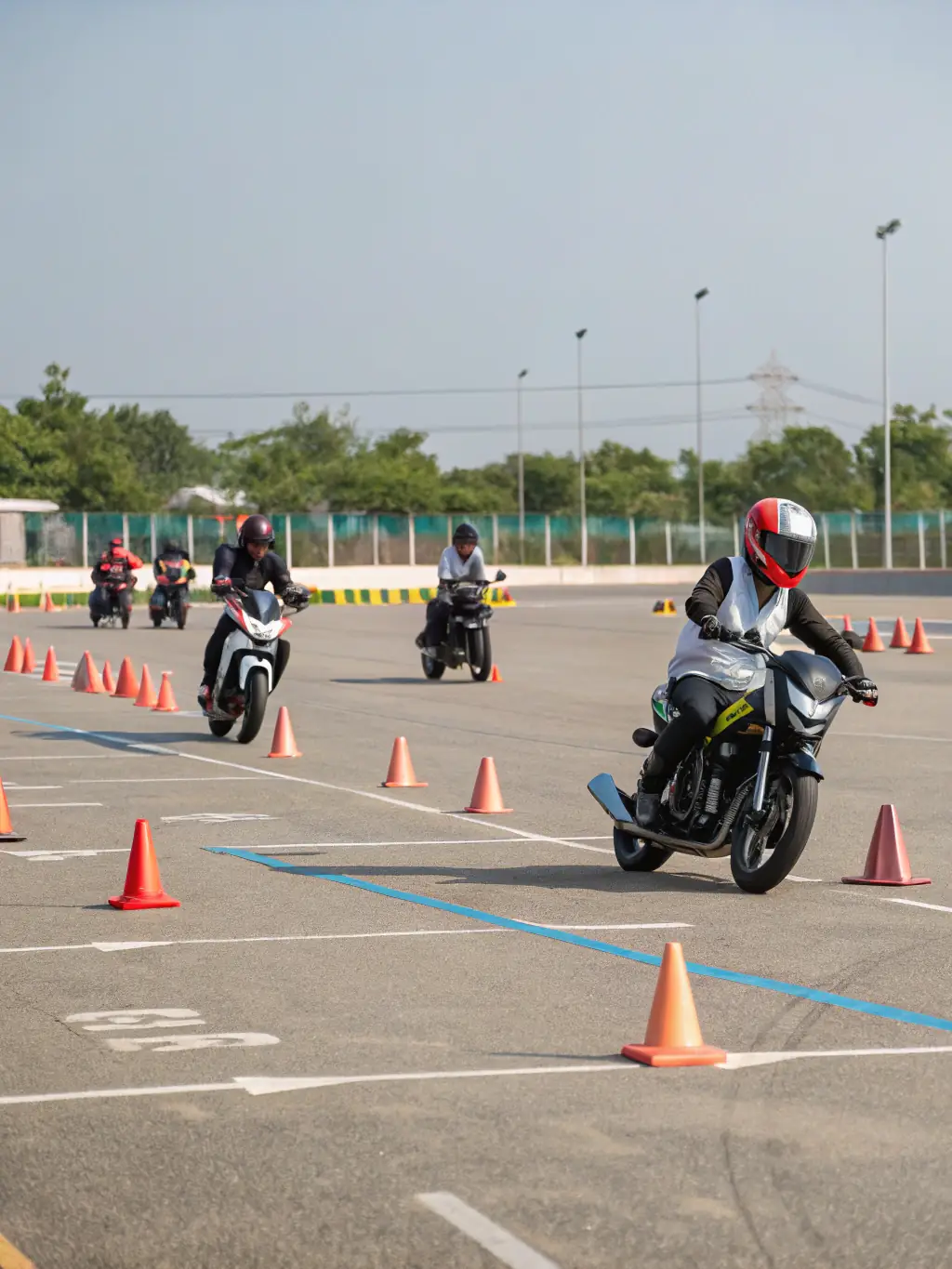 A photograph of participants at a TEAM GRIP ATTACK road safety awareness event, interacting with instructors and learning about safe riding practices.